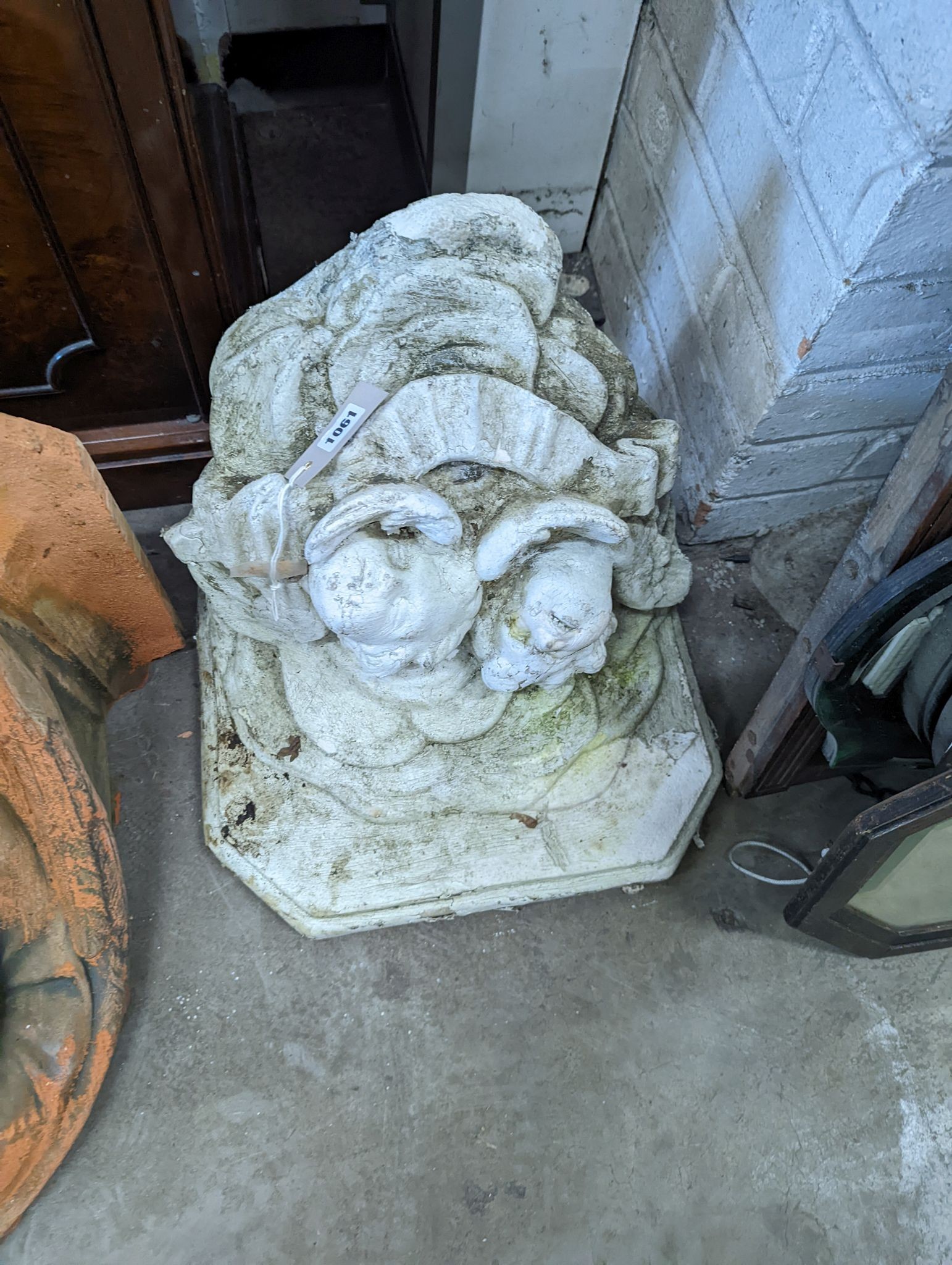 Two reconstituted stone and terracotta garden wall brackets, larger width 44cm, height 44cm